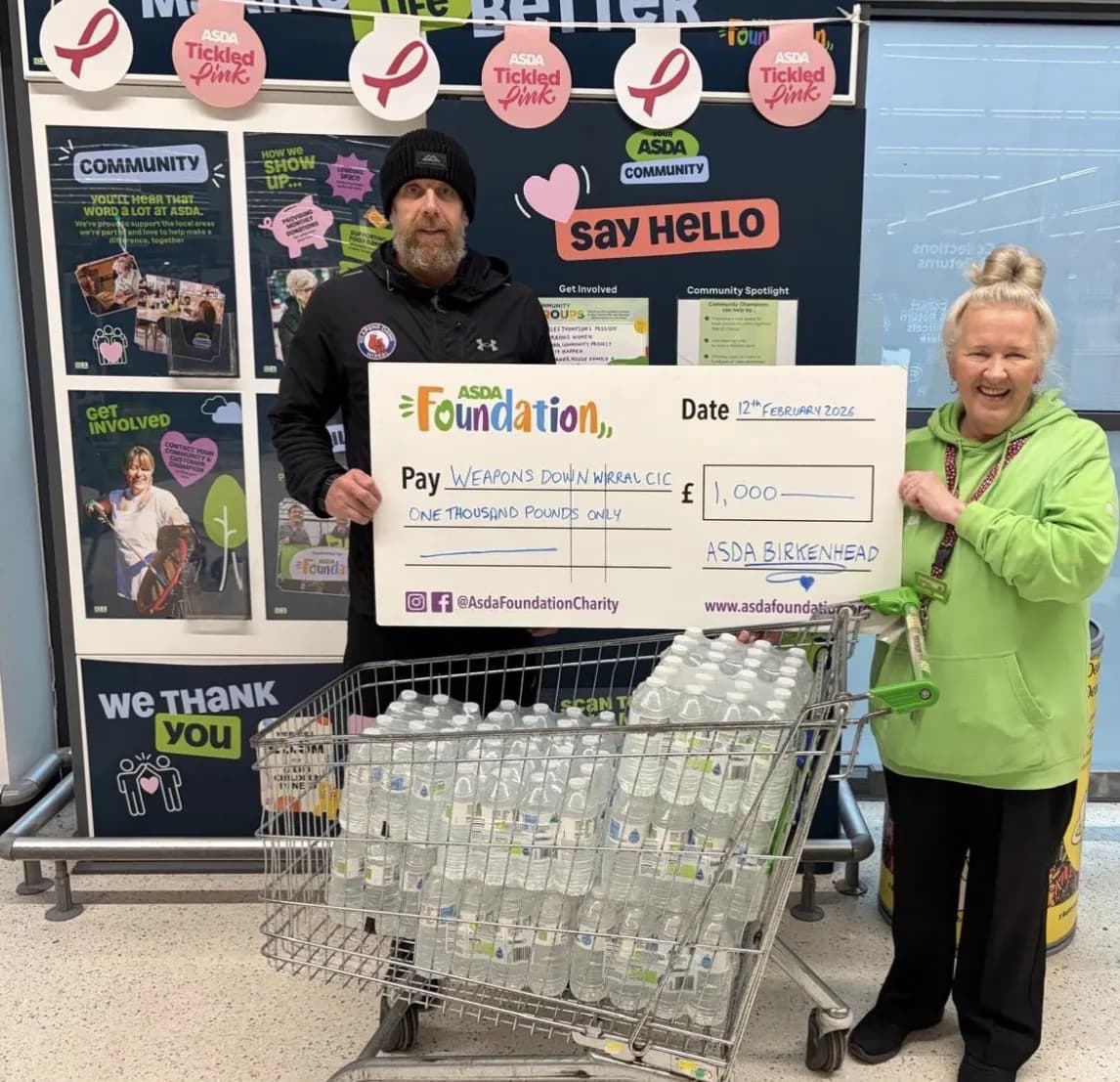 Community supporters presenting donations for Weapons Down Wirral