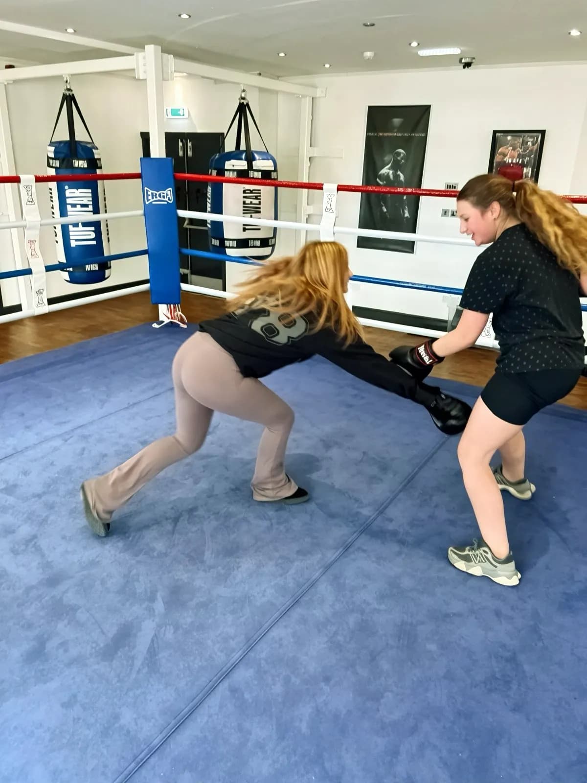A coach supporting a young person during training