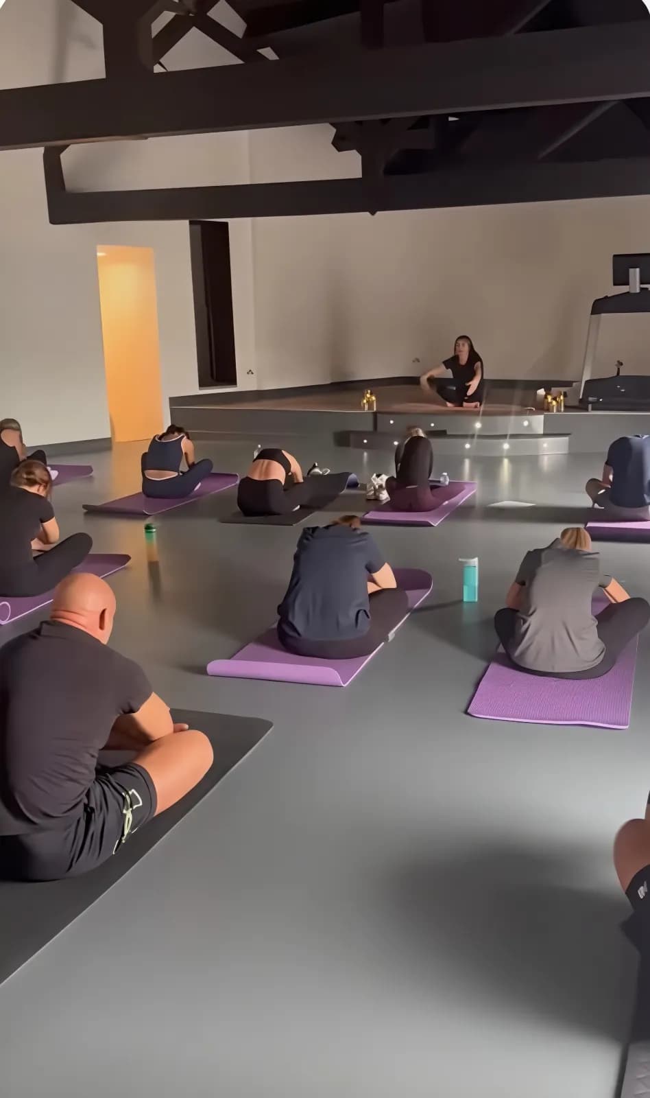 Adults taking part in a yoga session